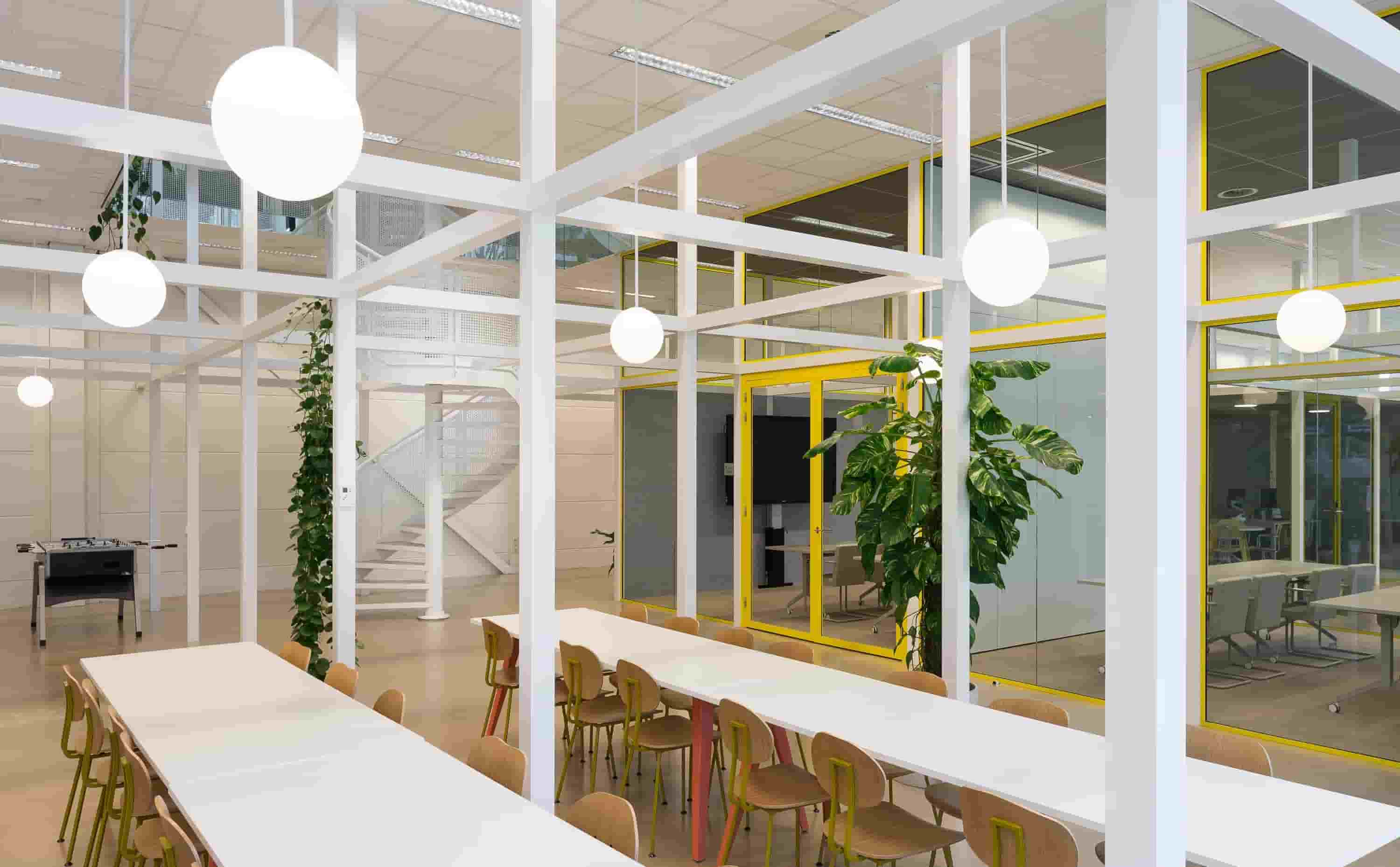 Spacious office with two set of tables and chairs 