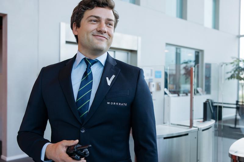 Workrate male security guard smiling at data center entrance