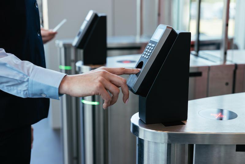 Workrate security guard scanning fingerprint at access device